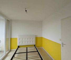 Application de la peinture de finition sur les murs d’une chambre à Chambéry